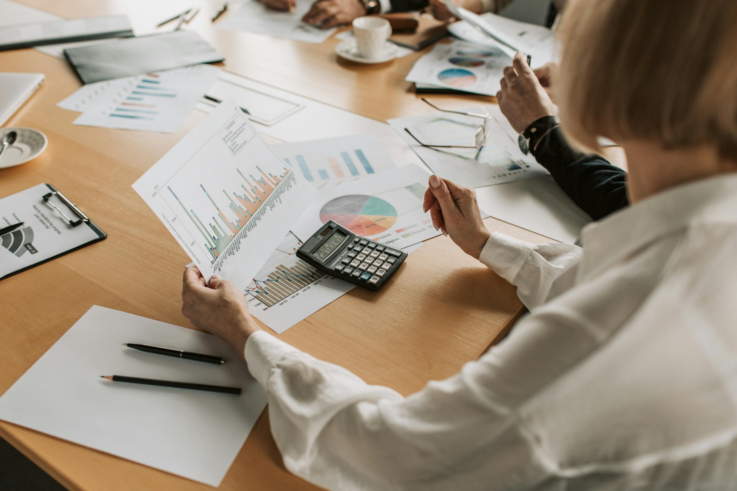 Nonprofit board analyzing financial data and graphs during a meeting.